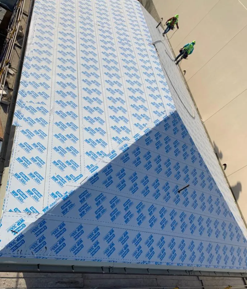 Professional roofers installing underlayment on a metal roof in Eagleton Village